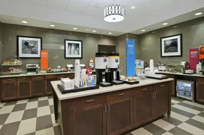 a coffee shop with a coffee maker on a counter at Hampton Inn & Suites Columbus/University Area in Columbus