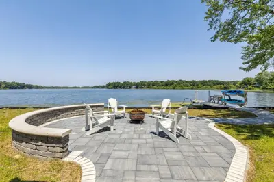 a patio with chairs and a table and water at Landmark Lakehouse - luxury living in PLX in Akron
