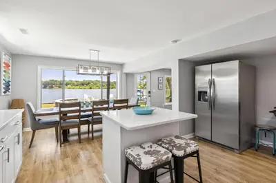 a kitchen and dining room with a large kitchen and a dining table at Landmark Lakehouse - luxury living in PLX in Akron