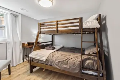 a bedroom with two bunk beds in a room at Landmark Lakehouse - luxury living in PLX in Akron