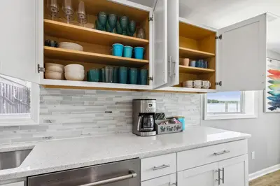 a kitchen with white cabinets and a coffee maker at Landmark Lakehouse - luxury living in PLX in Akron