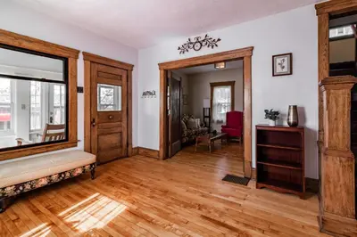 a living room with wooden floors and a door at Walk to Downtown Kent - 3 BR House w Patio & Yard in Kent