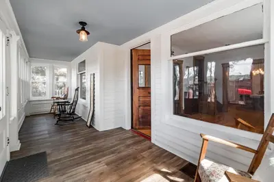 a hallway with white walls and a wooden door at Walk to Downtown Kent - 3 BR House w Patio & Yard in Kent