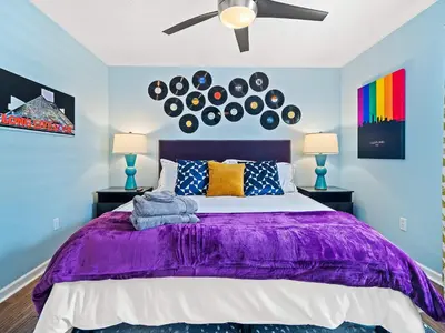 a bedroom with a purple bed with two lamps at Steps to CLE Clinic - Great for Families - ADA in Cleveland