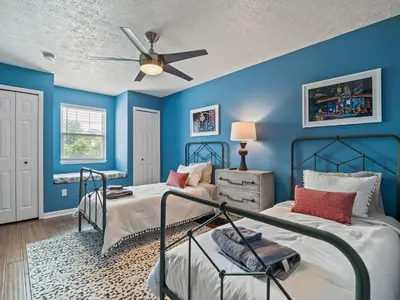 a blue bedroom with two beds and a ceiling fan at Steps to CLE Clinic - Great for Families - ADA in Cleveland