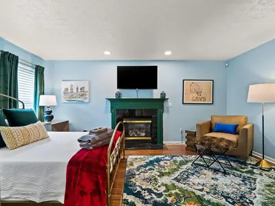a bedroom with a bed and a fireplace and a tv at Steps to CLE Clinic - Great for Families - ADA in Cleveland