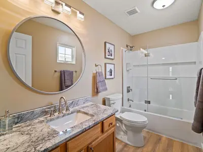 a bathroom with a sink and a toilet and a mirror at Steps to CLE Clinic - Great for Families - ADA in Cleveland