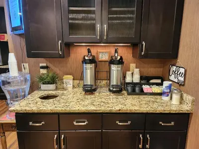 a kitchen counter with two kettles on top of it at Ashley Quarters Hotel Airport-Cincinnati in Florence