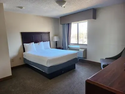a hotel room with a bed and a window at Ashley Quarters Hotel Airport-Cincinnati in Florence
