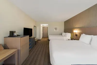 a hotel room with two beds and a television at Country Inn & Suites by Radisson, Findlay, OH in Findlay