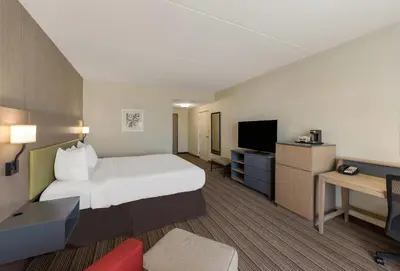 a hotel room with a bed and a television at Country Inn & Suites by Radisson, Findlay, OH in Findlay