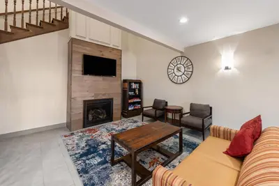 a living room with a couch and a fireplace at Country Inn & Suites by Radisson, Findlay, OH in Findlay