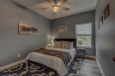 a bedroom with a bed and a ceiling fan at 100 Acre Relaxing Retreat Near ARK - The Cottage in Williamstown