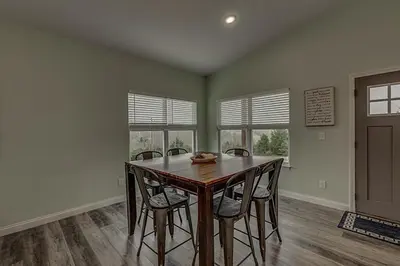 a dining room with a wooden table and chairs at 100 Acre Relaxing Retreat Near ARK - The Cottage in Williamstown