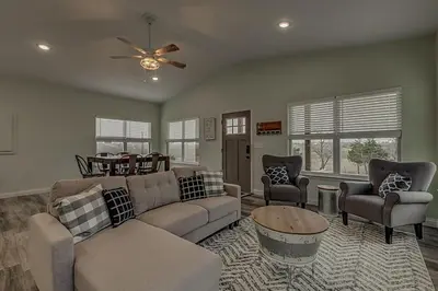a living room with a couch and a table and chairs at 100 Acre Relaxing Retreat Near ARK - The Cottage in Williamstown