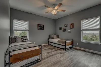a bedroom with two beds and a ceiling fan at 100 Acre Relaxing Retreat Near ARK - The Cottage in Williamstown