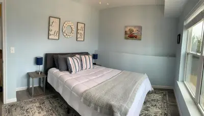 a bedroom with a bed and a window at 100 Acre Relaxing Retreat Near ARK- The Farmhouse in Williamstown