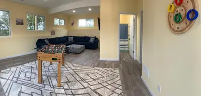 a living room with a chess table and a couch at 100 Acre Relaxing Retreat Near ARK- The Farmhouse in Williamstown