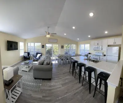 a large kitchen and living room with a large island at 100 Acre Relaxing Retreat Near ARK- The Farmhouse in Williamstown