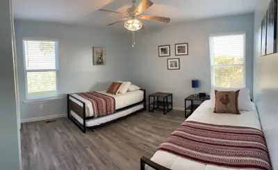 a bedroom with two beds and a ceiling fan at 100 Acre Relaxing Retreat Near ARK- The Farmhouse in Williamstown