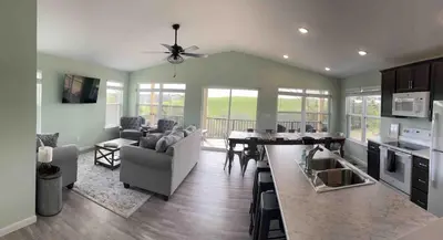 a kitchen and living room with a table and chairs at 100 Acre Relaxing Retreat Near ARK- The Woodlands in Williamstown