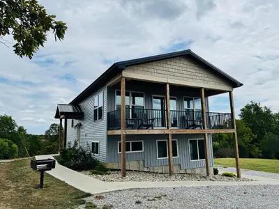a house with a balcony on the side of it at 100 Acre Relaxing Retreat Near ARK- The Woodlands in Williamstown