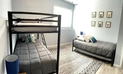 a bedroom with two bunk beds and a couch at 100 Acre Relaxing Retreat Near ARK- The Woodlands in Williamstown
