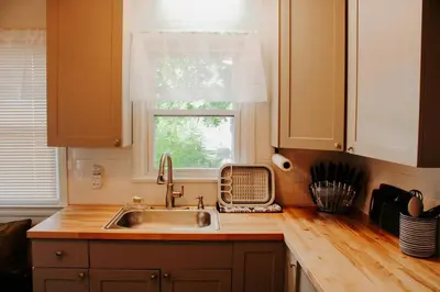 a kitchen with a sink and a window at Cozy house near Lake Erie, 10 minutes to Downtown. in Cleveland