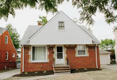 a red brick house with a white door at Cozy house near Lake Erie, 10 minutes to Downtown. in Cleveland
