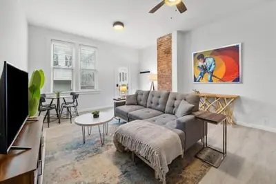 a living room with a couch and a table at Charming Mt. Adams 1BR - Near Downtown & Stadiums in Cincinnati