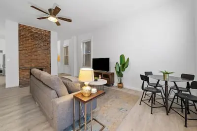 a living room with a couch and a table at Charming Mt. Adams 1BR - Near Downtown & Stadiums in Cincinnati