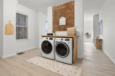 a laundry room with a washer and dryer in it at Charming Mt. Adams 1BR - Near Downtown & Stadiums in Cincinnati