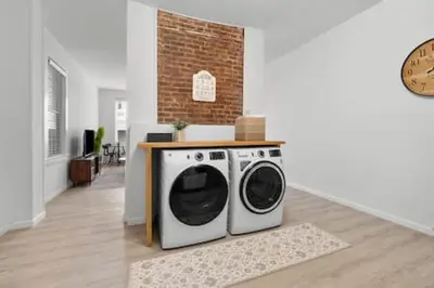 a washer and dryer in a living room at Charming Mt. Adams 1BR - Near Downtown & Stadiums in Cincinnati