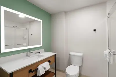 a bathroom with a white sink and a mirror at Wingate Suites By Wyndham Mansfield Ontario in Mansfield