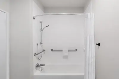 a bathroom with a shower with a shower curtain at Wingate Suites By Wyndham Mansfield Ontario in Mansfield