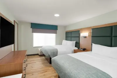 a hotel room with two beds and a window at Wingate Suites By Wyndham Mansfield Ontario in Mansfield
