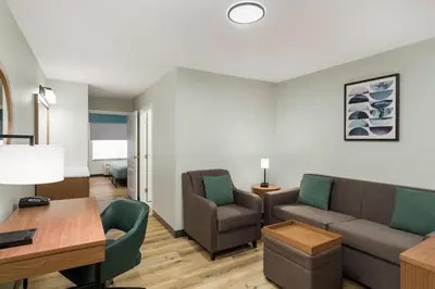 a living room with a couch and chairs and a table at Wingate Suites By Wyndham Mansfield Ontario in Mansfield