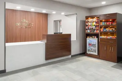 a store lobby with a cash register and a refrigerator at Wingate Suites By Wyndham Mansfield Ontario in Mansfield