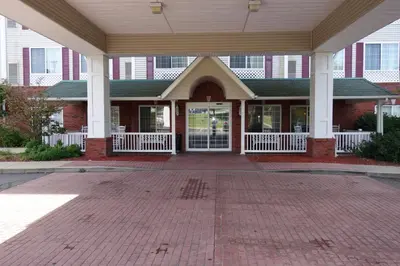 a front porch of a building with a brick floor at Wingate Suites by Wyndham Youngstown - Austintown in Youngstown