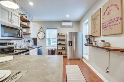 a kitchen with a stainless steel refrigerator at Historic Loveland Apt Walk to Little Miami River! in Loveland