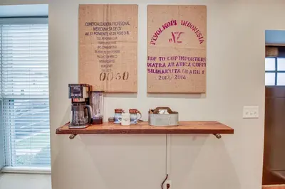 a kitchen with a wooden counter top with a coffee maker at Historic Loveland Apt Walk to Little Miami River! in Loveland