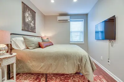 a bedroom with a bed and a television in it at Historic Loveland Apt Walk to Little Miami River! in Loveland