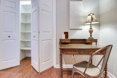 an office with a desk with a lamp and a chair at Historic Loveland Apt Walk to Little Miami River! in Loveland