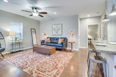 a living room with a couch and a table at Historic Loveland Apt Walk to Little Miami River! in Loveland