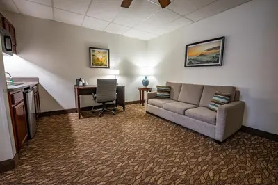 a living room with a couch and a desk at Christopher Inn and Suites in Chillicothe