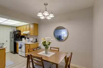 a kitchen with a table with a vase of flowers on it at Toledo Vacation Rental about 8 Mi to Downtown! in Toledo