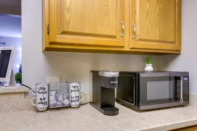 a kitchen counter with a microwave and a coffee maker at Toledo Vacation Rental about 8 Mi to Downtown! in Toledo
