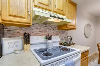 a kitchen with a white stove top oven at Toledo Vacation Rental about 8 Mi to Downtown! in Toledo