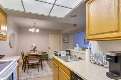 a kitchen with a sink and a table at Toledo Vacation Rental about 8 Mi to Downtown! in Toledo