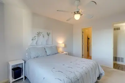 a bedroom with a white bed and a ceiling fan at Toledo Vacation Rental about 8 Mi to Downtown! in Toledo